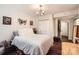 Well-lit bedroom with modern lighting, hardwood floors and bright white walls at 8904 Saint Pierre Ln, Charlotte, NC 28277