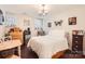 Cozy bedroom features a chandelier, hardwood floors, and plentiful natural light at 8904 Saint Pierre Ln, Charlotte, NC 28277