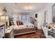 Bedroom featuring a chandelier, a large bed, and hardwood floors at 8904 Saint Pierre Ln, Charlotte, NC 28277