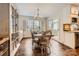 Well-lit dining room with hardwood floors, chandelier, cabinet and a view of the outdoors at 8904 Saint Pierre Ln, Charlotte, NC 28277