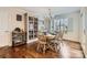 Inviting dining room featuring hardwood floors, natural light, and a stylish display cabinet at 8904 Saint Pierre Ln, Charlotte, NC 28277