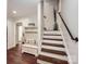 Inviting entryway with wood floors, a bench, and a staircase at 8904 Saint Pierre Ln, Charlotte, NC 28277