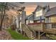 Charming home's exterior featuring a wooden deck with hot tub, perfect for relaxation and outdoor enjoyment at 8904 Saint Pierre Ln, Charlotte, NC 28277
