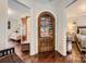 Hallway with an arched-glass door leading to a closet and views into adjoining rooms at 8904 Saint Pierre Ln, Charlotte, NC 28277