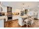 Bright kitchen features a brick backsplash, stainless steel appliances, granite counters and a large center island with seating at 8904 Saint Pierre Ln, Charlotte, NC 28277