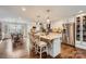Open kitchen featuring granite countertops, stainless steel appliances, an island with seating, and access to dining area at 8904 Saint Pierre Ln, Charlotte, NC 28277