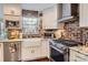 Charming kitchen with stainless steel appliances, farmhouse sink, brick backsplash, and granite countertops at 8904 Saint Pierre Ln, Charlotte, NC 28277