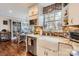 Bright kitchen with stainless steel appliances, farmhouse sink, brick backsplash, and view into the dining room at 8904 Saint Pierre Ln, Charlotte, NC 28277