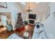 Bright living room with a fireplace, chandelier, christmas tree, and vaulted ceilings at 8904 Saint Pierre Ln, Charlotte, NC 28277