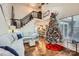 Bright, open-concept living room features hardwood floors, staircase, and access to the kitchen with holiday decorations at 8904 Saint Pierre Ln, Charlotte, NC 28277