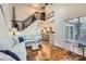 Bright, open-concept living room features hardwood floors, staircase, and access to the kitchen at 8904 Saint Pierre Ln, Charlotte, NC 28277