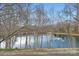 Scenic view of a tranquil pond with a fountain, surrounded by trees at 8904 Saint Pierre Ln, Charlotte, NC 28277