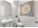 Well-lit half bathroom featuring pedestal sink and decorative wall art at 9108 Ainslie Downs St, Charlotte, NC 28273