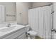 Clean bathroom featuring a white vanity, toilet, and shower with a white curtain at 9108 Ainslie Downs St, Charlotte, NC 28273