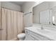 Bathroom with a toilet and vanity with white cabinets and a shower with a patterned curtain at 9108 Ainslie Downs St, Charlotte, NC 28273