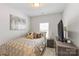 Comfortable bedroom features a tan headboard bed with luxurious brown and gold patterned bedding and wall decor at 9108 Ainslie Downs St, Charlotte, NC 28273