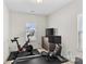 Well-equipped exercise room featuring modern Peloton bike and rowing machine for a complete workout at 9108 Ainslie Downs St, Charlotte, NC 28273