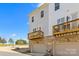 View of townhouse exteriors with garages and wooden balconies at 9108 Ainslie Downs St, Charlotte, NC 28273