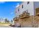 View of townhouse exteriors with garages and wooden balconies at 9108 Ainslie Downs St, Charlotte, NC 28273