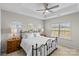 Bright main bedroom with a tray ceiling, ceiling fan and large windows at 9108 Ainslie Downs St, Charlotte, NC 28273