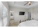 Bright main bedroom with tray ceiling, mounted TV and ensuite bathroom at 9108 Ainslie Downs St, Charlotte, NC 28273