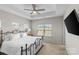 Bright main bedroom with a tray ceiling, ceiling fan and mounted television at 9108 Ainslie Downs St, Charlotte, NC 28273