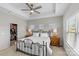 Bright main bedroom with a tray ceiling, ceiling fan, and walk-in closet at 9108 Ainslie Downs St, Charlotte, NC 28273