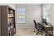 Functional office space featuring a wood desk, comfortable chair, and ample natural light at 9108 Ainslie Downs St, Charlotte, NC 28273