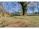 Quaint home nestled amongst mature trees with a large grassy front yard and partially covered front porch at 966 Marys Grove Rd, Cherryville, NC 28021