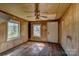 Living room with wood paneled walls and windows at 966 Marys Grove Rd, Cherryville, NC 28021