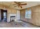 Living room with wood paneled walls and an inoperable fireplace at 966 Marys Grove Rd, Cherryville, NC 28021