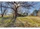 Property view with grassy lawn and mature trees, showing house and outbuildings at 966 Marys Grove Rd, Cherryville, NC 28021