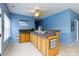 A built-in bar area with wood cabinets, stone countertop and tile flooring adds a touch of elegance at 1038 Rolling Park Ln, Fort Mill, SC 29715