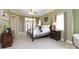 Spacious bedroom with a four-poster bed, green walls, carpet floors and double doors at 1038 Rolling Park Ln, Fort Mill, SC 29715