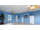 Spacious blue bonus room with ceiling fans, tile floors, and ample natural light from a large window at 1038 Rolling Park Ln, Fort Mill, SC 29715