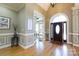 Inviting foyer featuring hardwood floors, arched doorway and wainscoting detail at 1038 Rolling Park Ln, Fort Mill, SC 29715