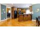 Stylish kitchen with wooden cabinetry, modern appliances, hardwood floors and an island at 1038 Rolling Park Ln, Fort Mill, SC 29715