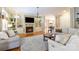 Cozy living room with a fireplace, built-in shelves, and comfortable seating at 1038 Rolling Park Ln, Fort Mill, SC 29715