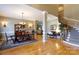 Open-concept living room with dining area, hardwood floors, and spiral staircase at 1038 Rolling Park Ln, Fort Mill, SC 29715