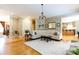 Bright living room featuring hardwood floors, a chandelier, and a large sectional sofa at 1038 Rolling Park Ln, Fort Mill, SC 29715