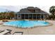 Backyard pool and patio area featuring a diving board, hot tub, and screened porch at 1038 Rolling Park Ln, Fort Mill, SC 29715