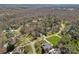 Aerial shot showcasing a neighborhood surrounded by lush forest and spacious yards with mature trees at 105 Elizabeth Brook Dr, Davidson, NC 28036