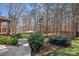 Spacious backyard featuring a patio with umbrella table, manicured lawn, and surrounding trees for privacy at 105 Elizabeth Brook Dr, Davidson, NC 28036