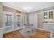 Bright breakfast nook features a round table, white cabinets, and sliding barn doors to a closet at 105 Elizabeth Brook Dr, Davidson, NC 28036