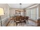 Dining room featuring a large wooden table, elegant chandelier, and natural lighting at 105 Elizabeth Brook Dr, Davidson, NC 28036