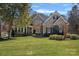 Attractive brick home with well-maintained lawn and landscaping, showcasing its inviting curb appeal at 105 Elizabeth Brook Dr, Davidson, NC 28036