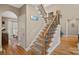 Inviting foyer features an oak and iron staircase and beautiful hardwood floors at 105 Elizabeth Brook Dr, Davidson, NC 28036