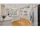 Spacious kitchen featuring white cabinets, stainless steel appliances, and a breakfast bar at 105 Elizabeth Brook Dr, Davidson, NC 28036