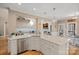 Bright, open kitchen with stainless steel appliances, island seating, and a view of the living room at 105 Elizabeth Brook Dr, Davidson, NC 28036