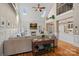 Spacious living room with a fireplace, high ceilings, and seamless flow to the kitchen at 105 Elizabeth Brook Dr, Davidson, NC 28036